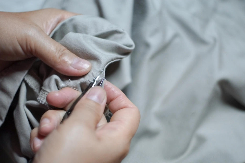 hands removing the sewn pieces with a toothpick