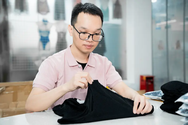 a quality control specialist checks the completed lingerie for consistency