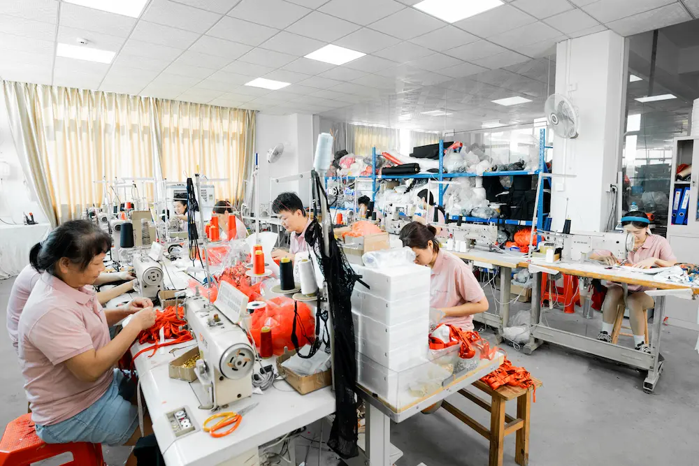 One of The Moment's seamsters in front of their sewing machines