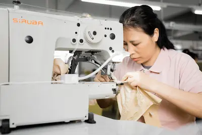 The Moment seamstress focused on assembling a custom lingerie