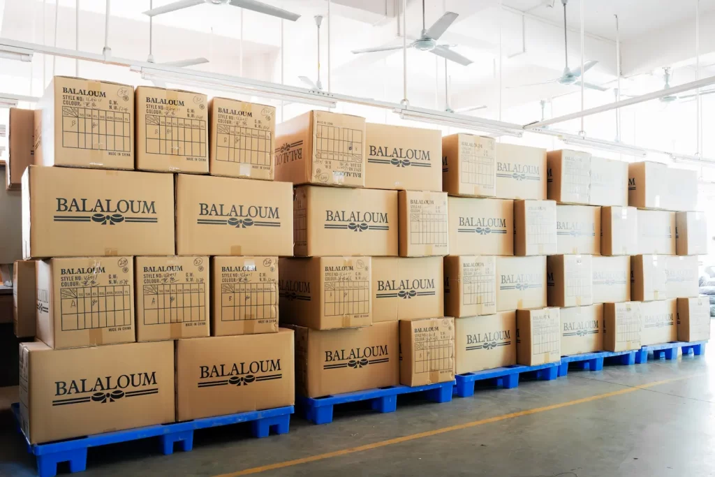 stacked cardboard boxes on top of forklift crates